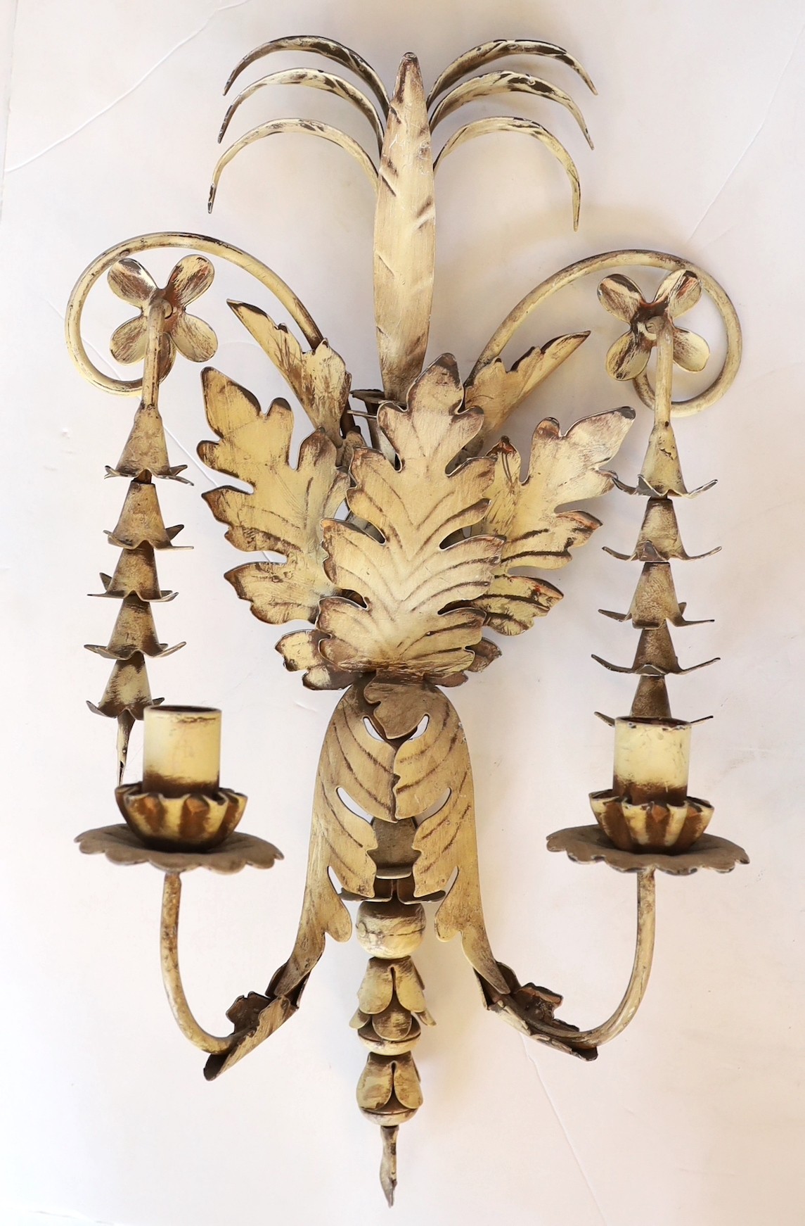 A set of four French white painted metal twin branch wall lights of foliate design, height 50cm. width 28 cm